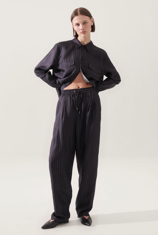 Image of a model wearing Pants. Product name - Twill Slouch Pants Pinstripe Black / White in Pinstripe Black/White colour by brand - Silk Laundry
