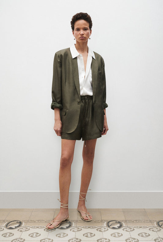 Image of a model wearing Shorts. Productname: Twill Slouch Shorts Pine in Pine colour by brand - Silk Laundry