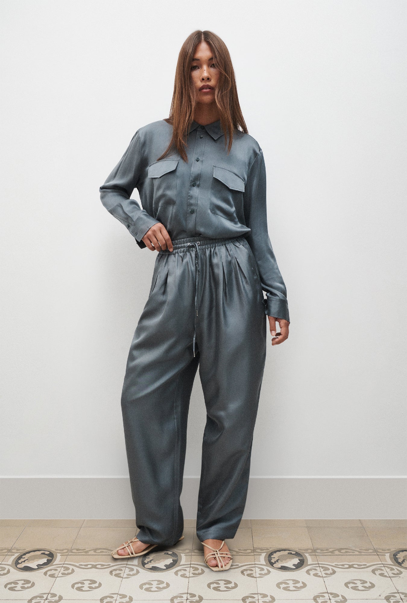 Image of a model wearing Pants. Product name - Twill Slouch Pants Slate in Slate colour by brand - Silk Laundry