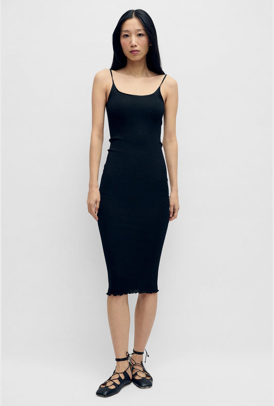Image of a model wearing Tops. Product name - Silk Wool Ribbed Essential Slip Black in Black colour by brand - Silk Laundry