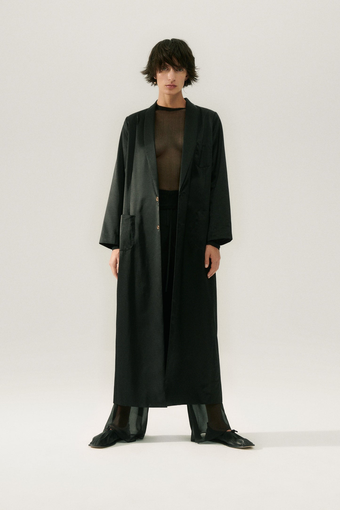 Image of a model wearing Outerwear. Product name - Weatherproof Long Blazer Black in Black colour by brand - Silk Laundry