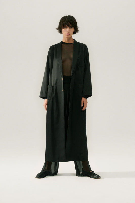 Image of a model wearing Outerwear. Product name - Weatherproof Long Blazer Black in Black colour by brand - Silk Laundry