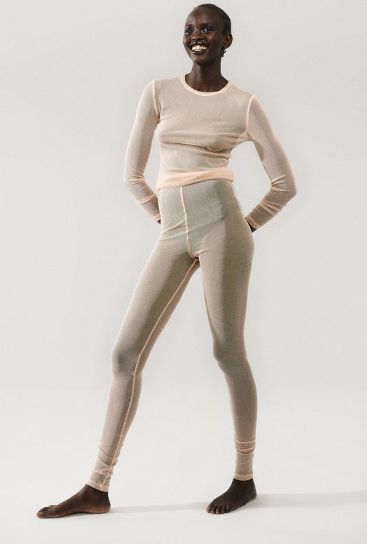 Image of a model wearing Pants. Product name - Mesh Leggings Daybreak in Daybreak colour by brand - Silk Laundry