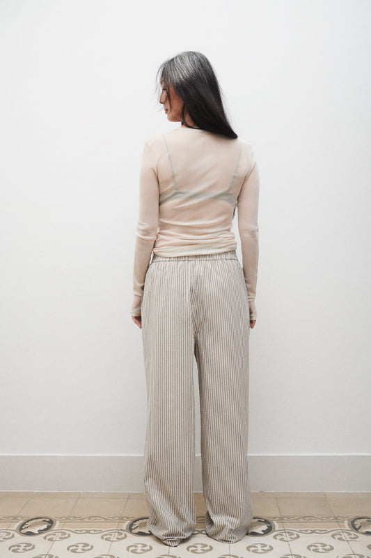 Image of a model wearing Pants. Product name - Cotton Paper Bag Pants Slate Stripe in Slate Stripe colour by brand - Silk Laundry