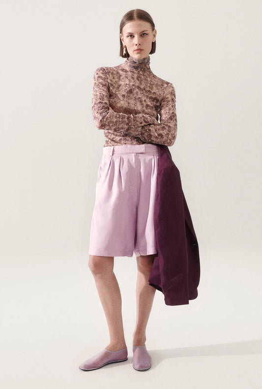 Image of a model wearing Shorts. Product name - Twill Double Pleated Shorts Lilac in Lilac colour by brand - Silk Laundry