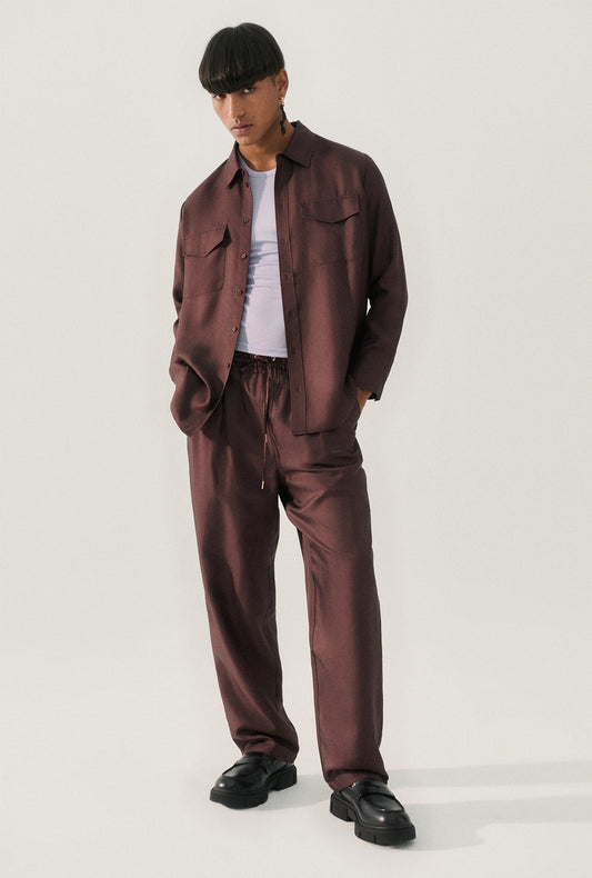 Image of a model wearing Pants. Product name - Twill Slouch Pants Cacao in Cacao colour by brand - Silk Laundry