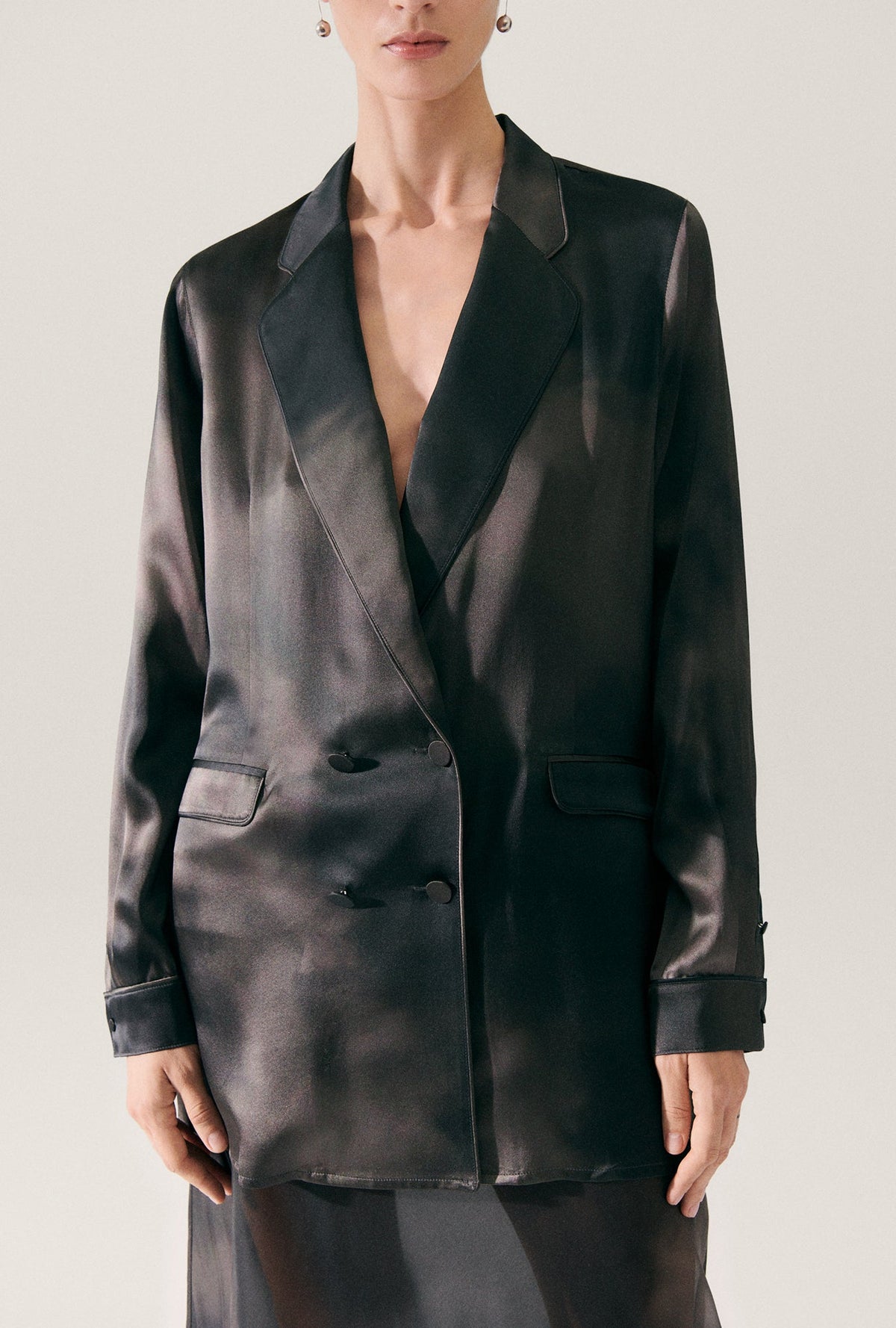 Image of a model wearing Outerwear. Product name - Relaxed Blazer Smoke in Smoke colour by brand - Silk Laundry