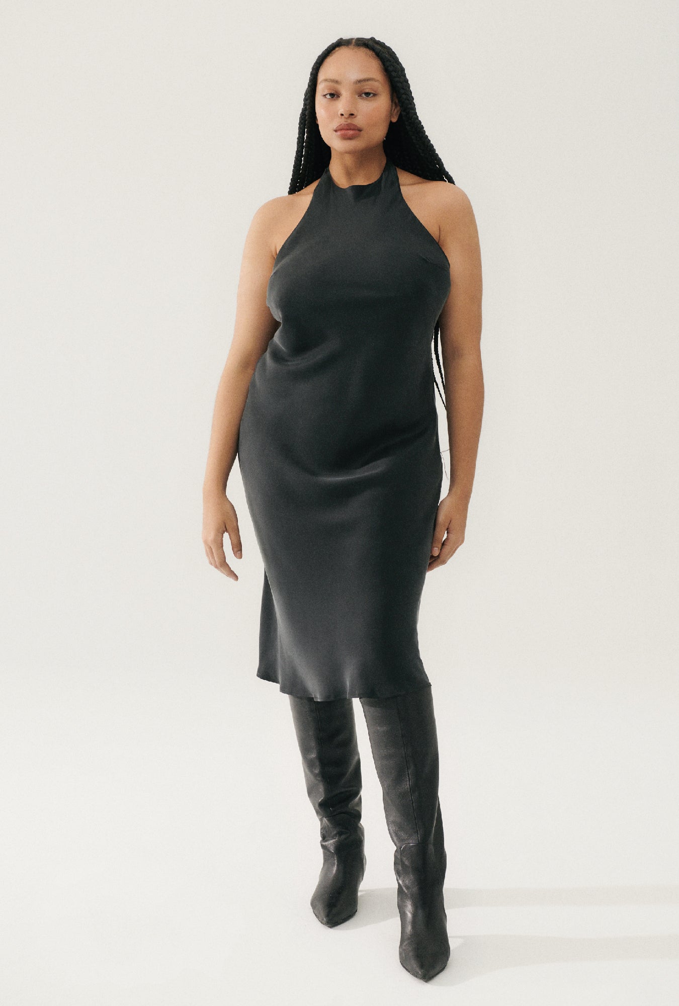Image of a model wearing Tops. Product name - Halter Dress Black in Black colour by brand - Silk Laundry