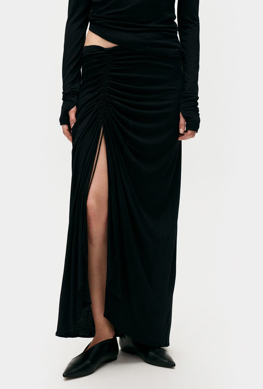 Image of a model wearing Tops. Product name - Jersey Modal Ruched Skirt Black in Black colour by brand - Silk Laundry