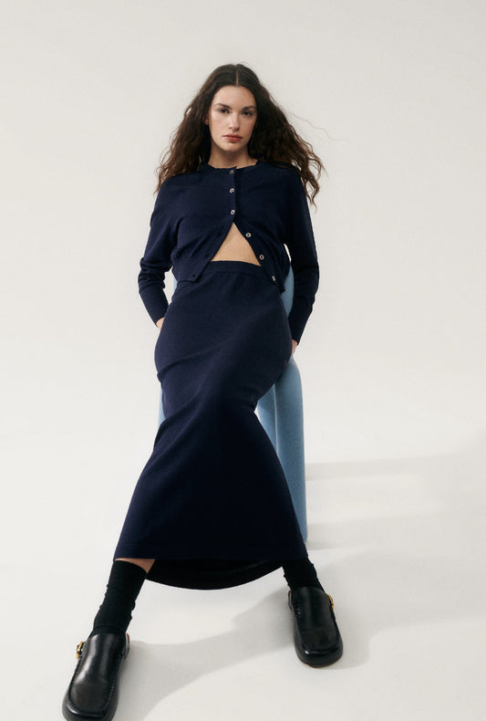 Image of a model wearing Skirts. Product name - Knit Straight Skirt Midnight in Midnight colour by brand - Silk Laundry