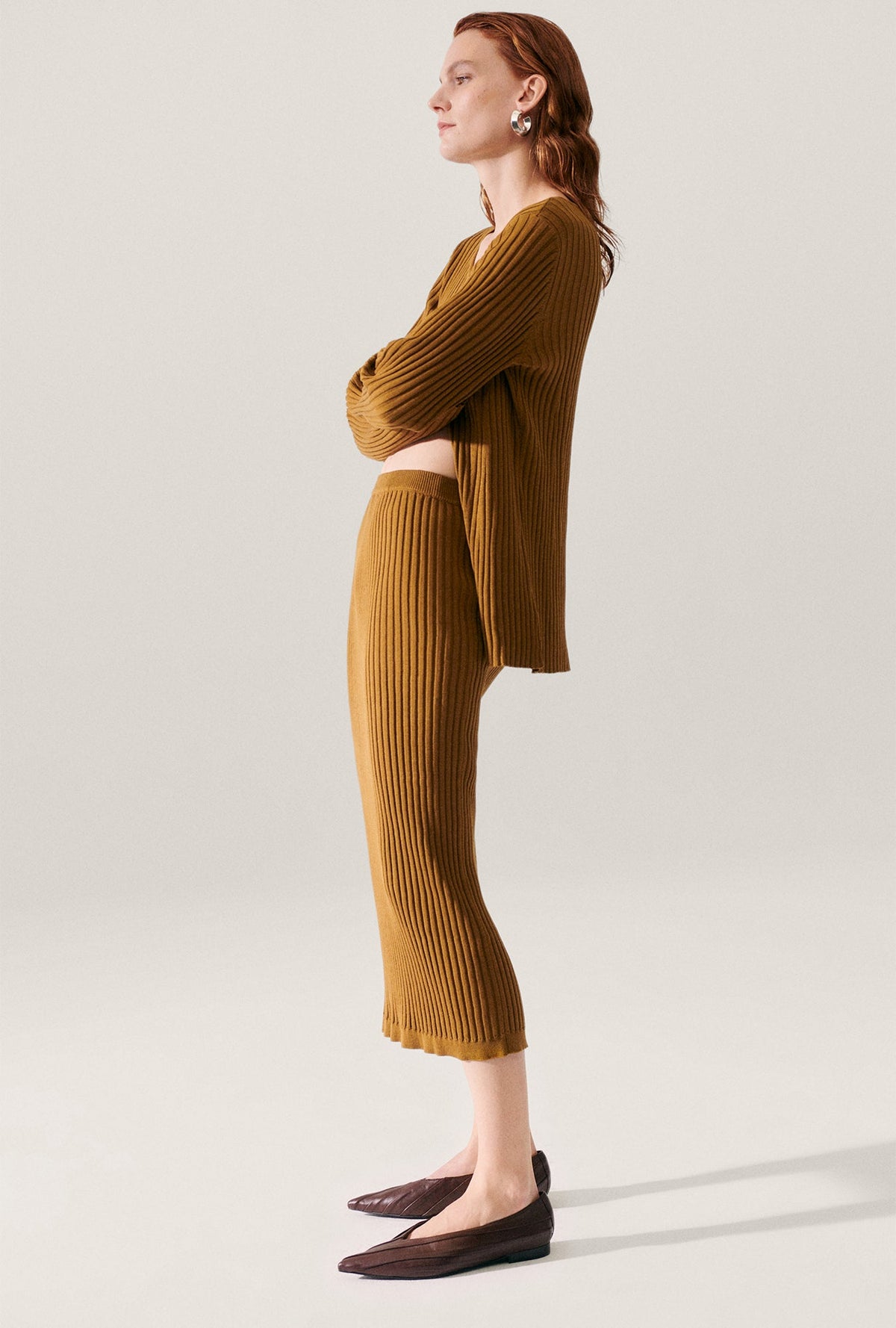 Image of a model wearing Skirts. Product name - Ribbed Straight Skirt Drought in Drought colour by brand - Silk Laundry