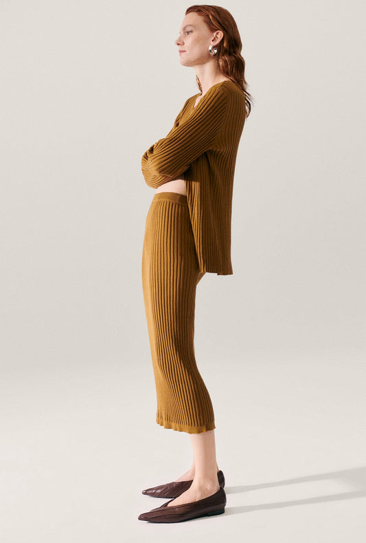Image of a model wearing Skirts. Product name - Ribbed Straight Skirt Drought in Drought colour by brand - Silk Laundry