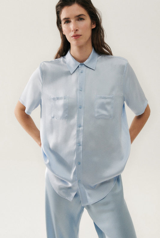 Image of a model wearing Tops. Productname: Short Sleeve Boyfriend Shirt Sky in Sky colour by brand - Silk Laundry