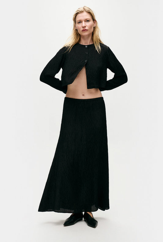Image of a model wearing Skirts. Productname: Silk Laundry Crinkle Long Bias Cut Skirt in Black colour by brand - Silk Laundry
