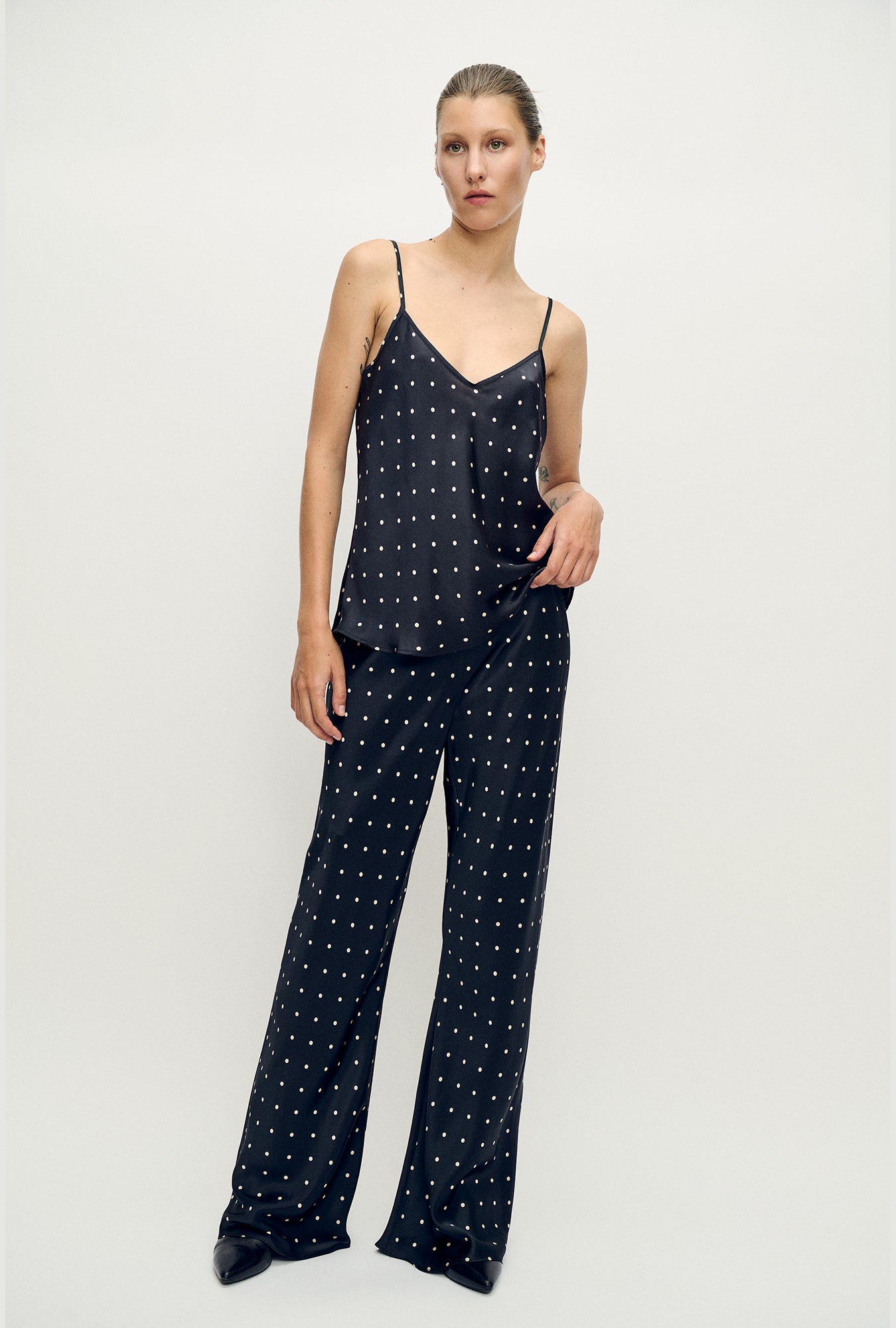 Image of a model wearing Pants. Product name - Bias Cut Pants Small Polka Dot in Small Polka Dot colour by brand - Silk Laundry