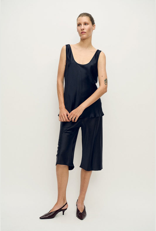 Image of a model wearing Pants. Product name - Pedal Pusher Black in Black colour by brand - Silk Laundry