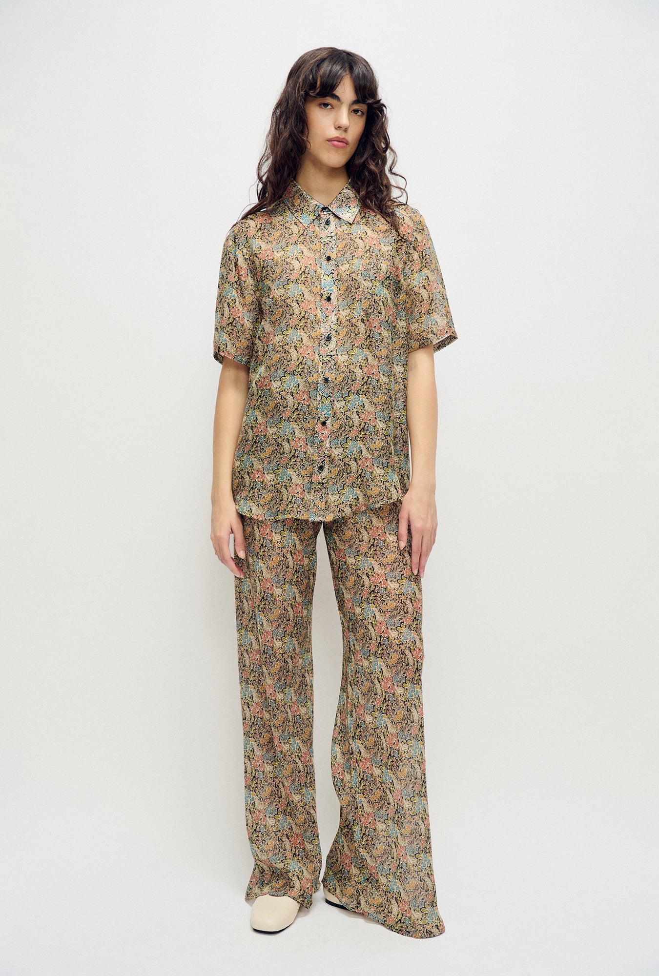 Image of a model wearing Tops. Product name - Chiffon Short Sleeve Boyfriend Shirt Sugar Floral in Sugar Floral colour by brand - Silk Laundry