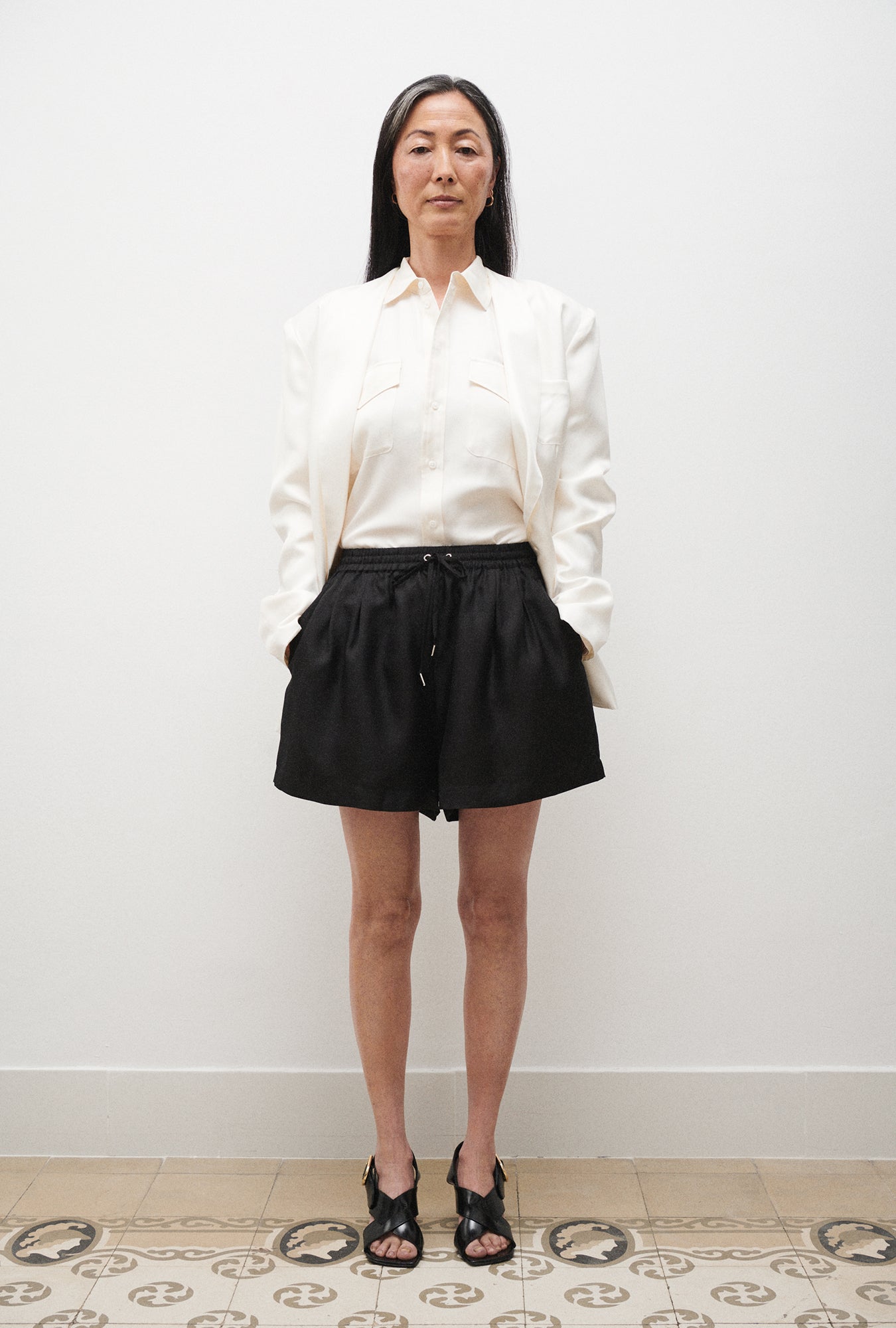 Image of a model wearing Shorts. Product name - Twill Slouch Shorts Black in Black colour by brand - Silk Laundry