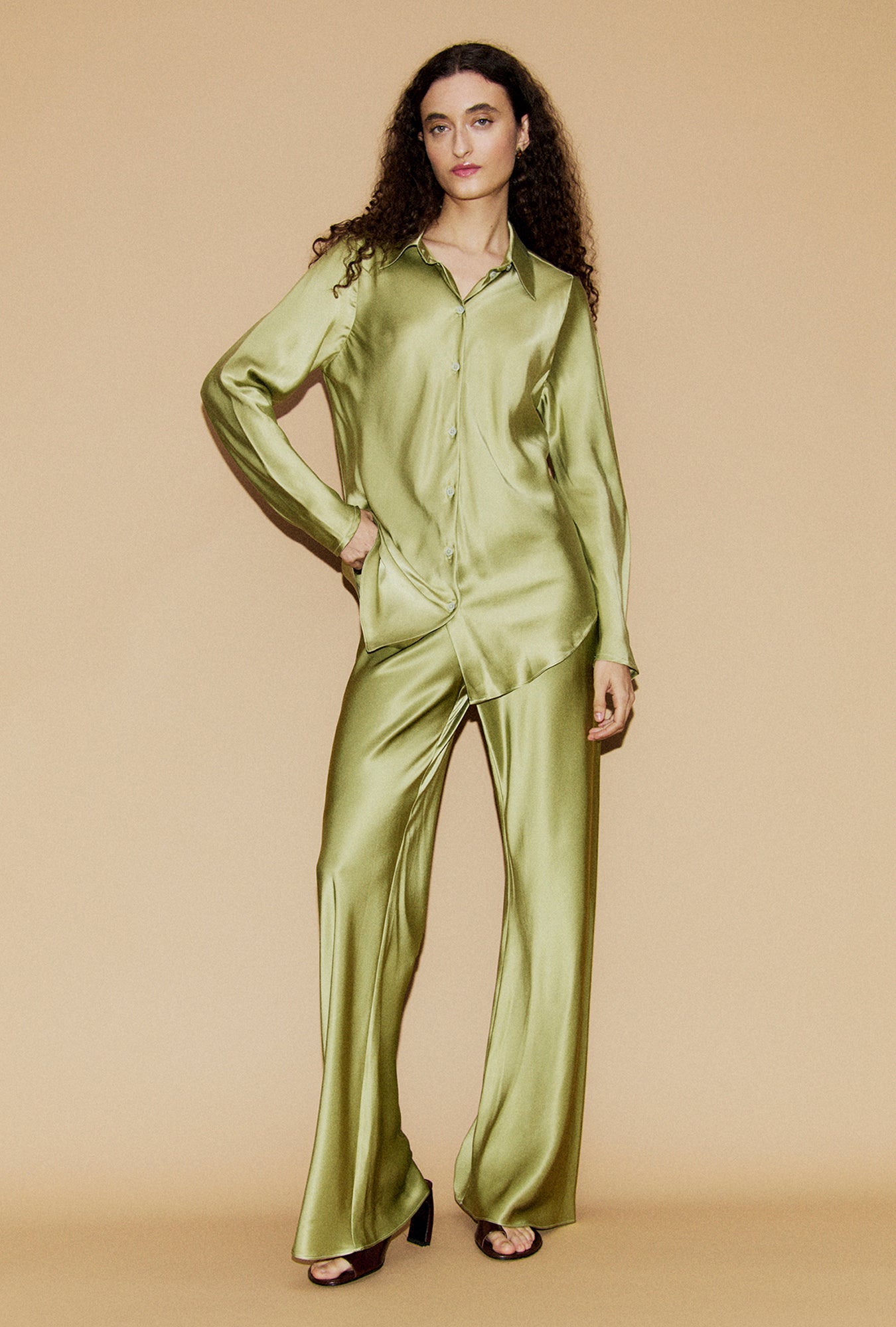 Image of a model wearing Pants. Product name - Bias Cut Pants Sage in Sage colour by brand - Silk Laundry