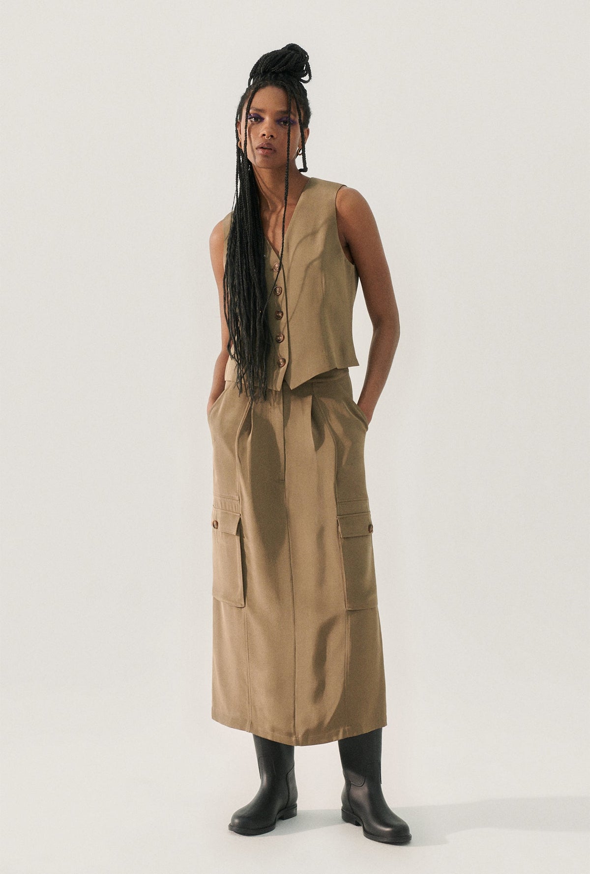 Image of a model wearing Skirts. Product name - CDC Long Suit Skirt Cub in Cub colour by brand - Silk Laundry