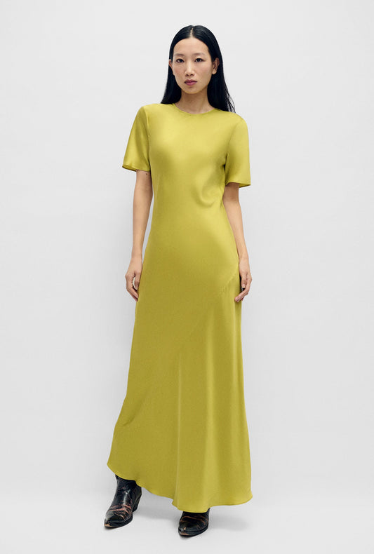 Image of a model wearing Tops. Product name - Short Sleeve Bias Dress Cactus in Cactus colour by brand - Silk Laundry