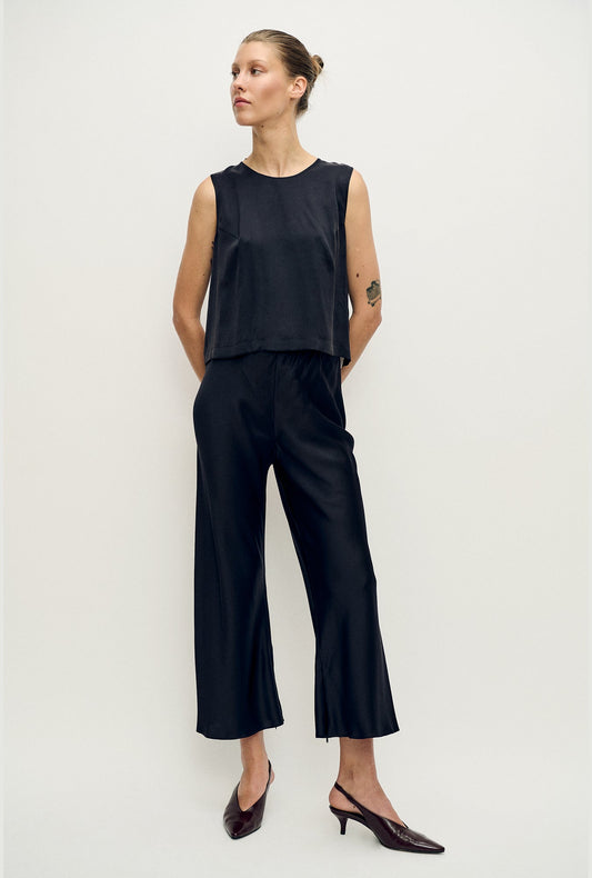 Image of a model wearing Pants. Productname: Cropped Bias Cut Pants Black Satin in Black Satin colour by brand - Silk Laundry