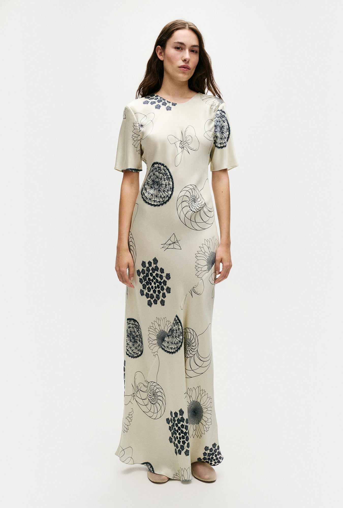Image of a model wearing Tops. Product name - Short Sleeve Bias Dress Fibonacci Off-White in Fibonacci Off-White colour by brand - Silk Laundry