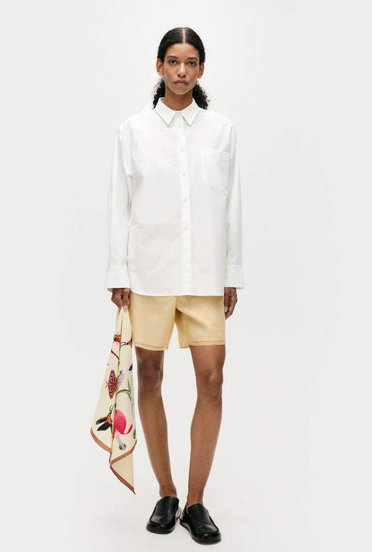 Image of a model wearing Tops. Productname: Silk Laundry Cotton Silk Pleated Yoke Shirt in White colour by brand - Silk Laundry