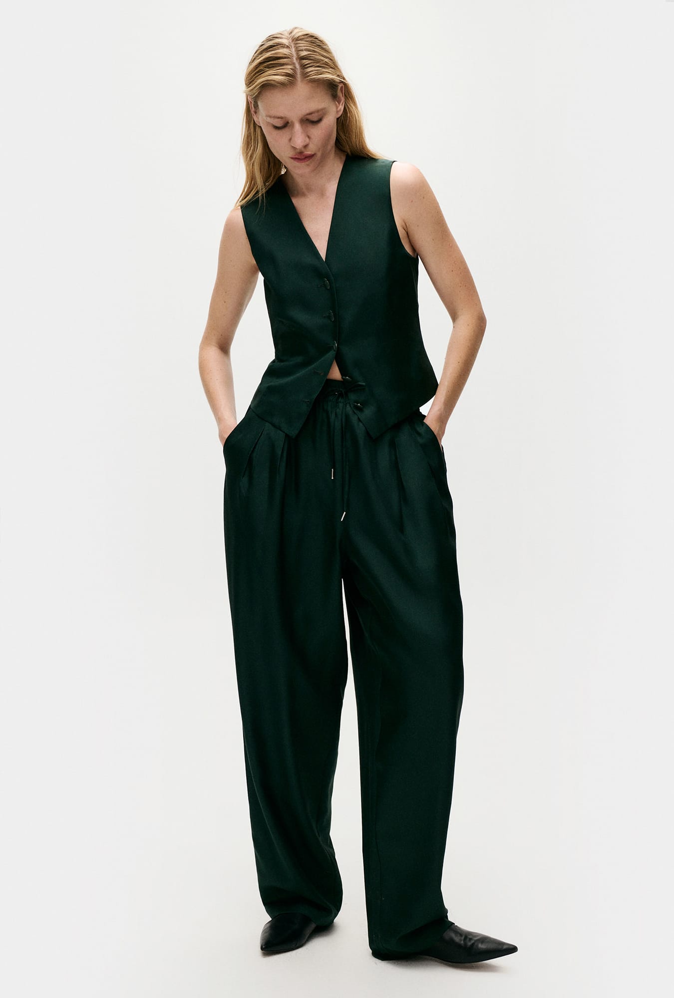 Image of a model wearing Pants. Product name - Twill Slouch Pants Scarab in Scarab colour by brand - Silk Laundry