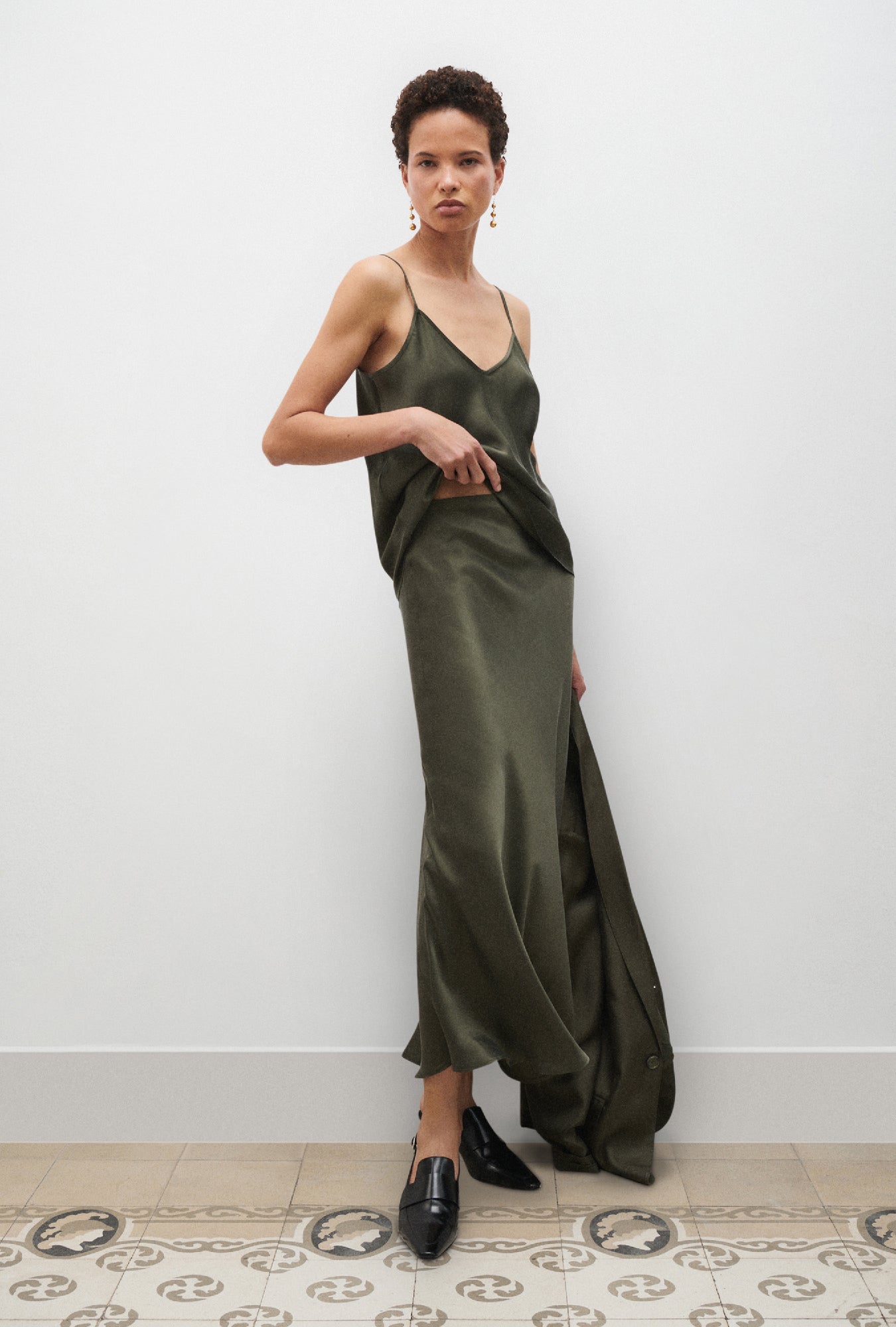 Image of a model wearing Skirts. Product name - Long Bias Cut Skirt Pine in Pine colour by brand - Silk Laundry