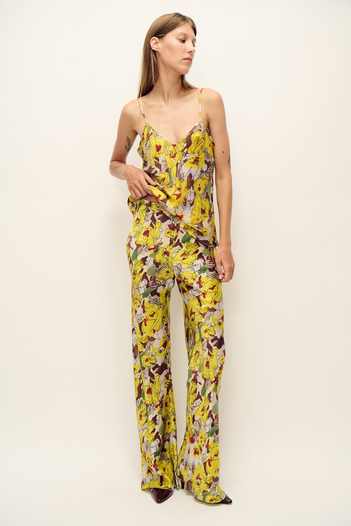 Image of a model wearing Pants. Product name - Bias Cut Pants Sunflower Floral in Sunflower Floral colour by brand - Silk Laundry