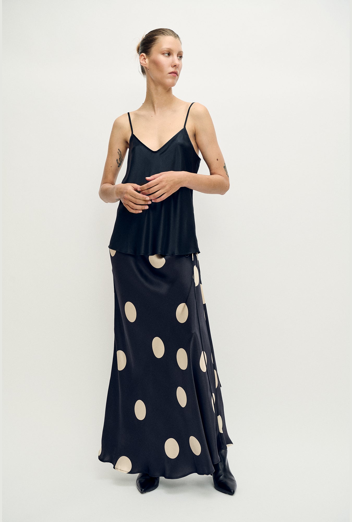 Image of a model wearing Skirts. Product name - Long Bias Cut Skirt Large Polka Dot in Large Polka Dot colour by brand - Silk Laundry