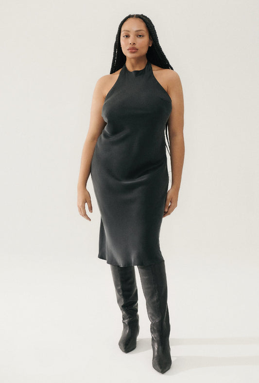 Image of a model wearing Tops. Productname: Halter Dress Black in Black colour by brand - Silk Laundry