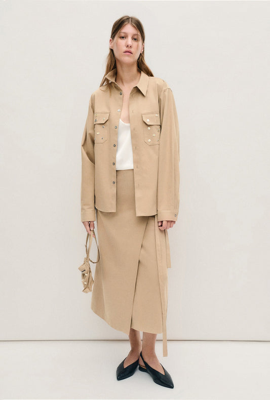 Image of a model wearing Skirts. Productname: Silk Laundry Pearl Wrap Skirt in Cowrie colour by brand - Silk Laundry