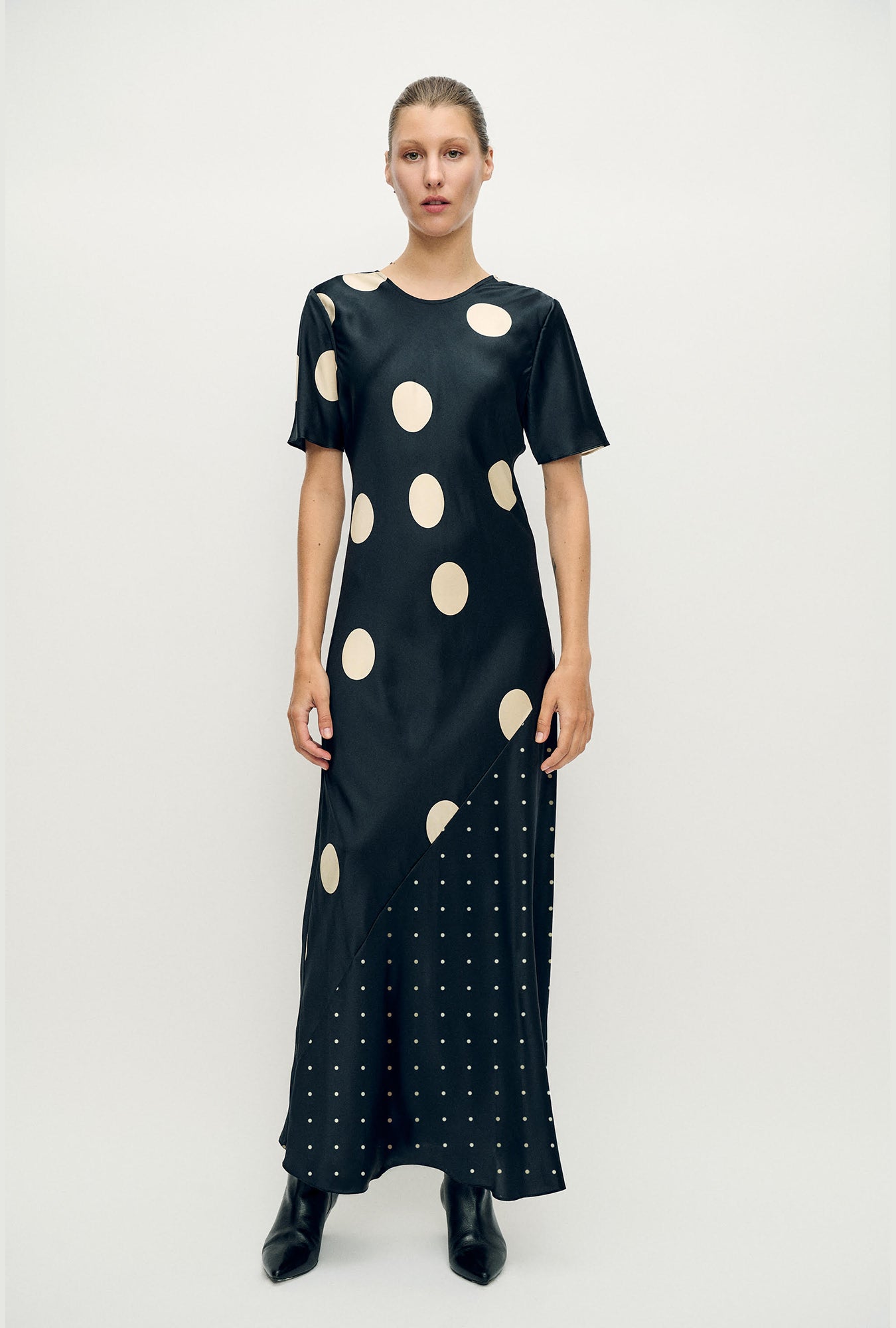 Image of a model wearing Tops. Product name - Short Sleeve Bias Dress Polka Mix in Polka Mix colour by brand - Silk Laundry