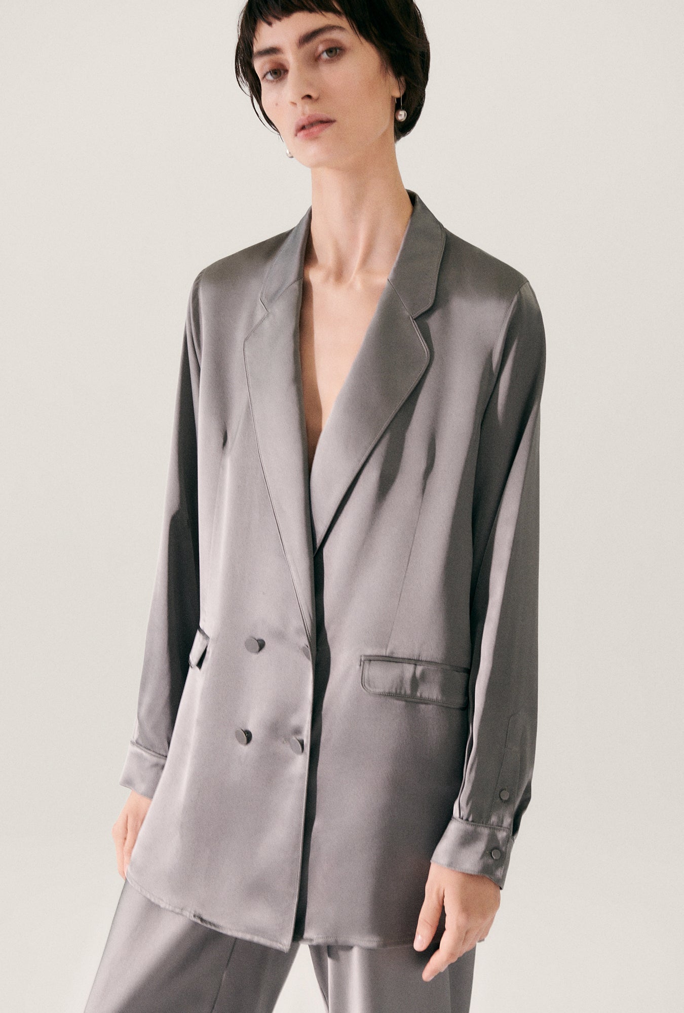 Image of a model wearing Outerwear. Product name - Relaxed Blazer Grey Pearl in Grey Pearl colour by brand - Silk Laundry