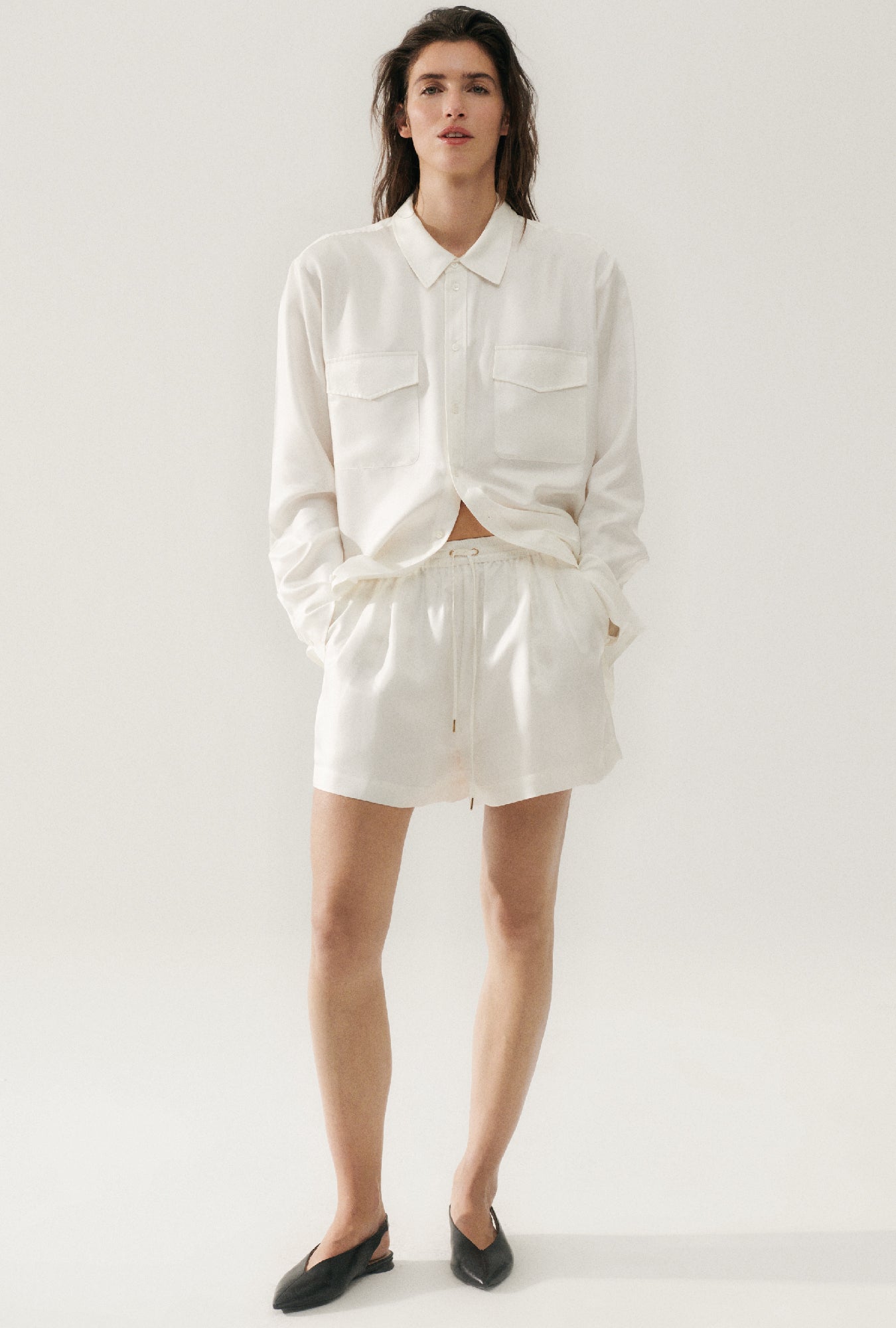 Image of a model wearing Shorts. Product name - Twill Slouch Shorts White in White colour by brand - Silk Laundry