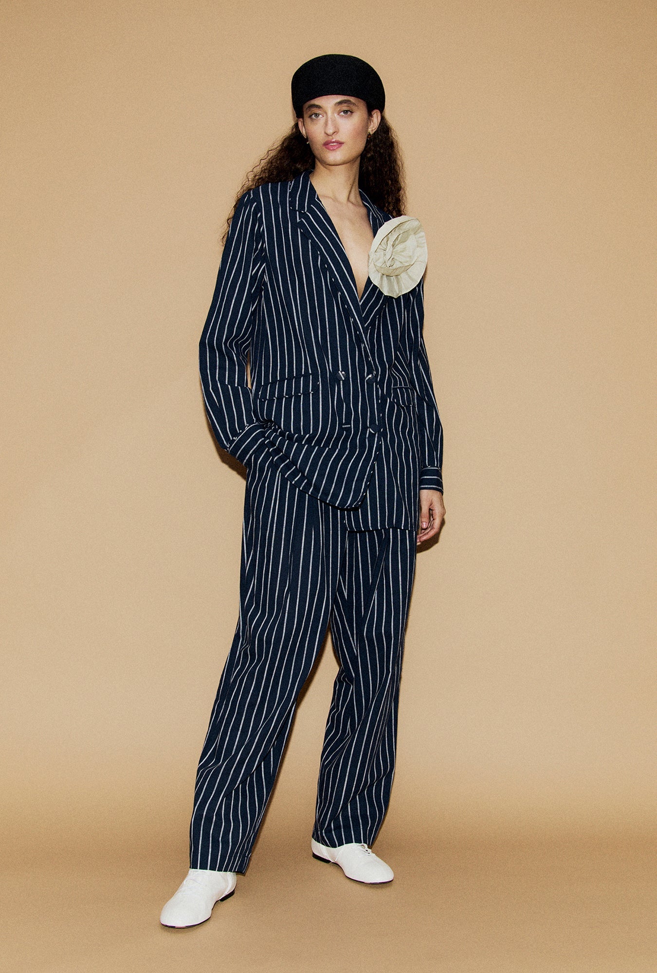 Image of a model wearing Pants. Product name - Cotton Slouch Pants Egret Stripe in Egret Stripe colour by brand - Silk Laundry