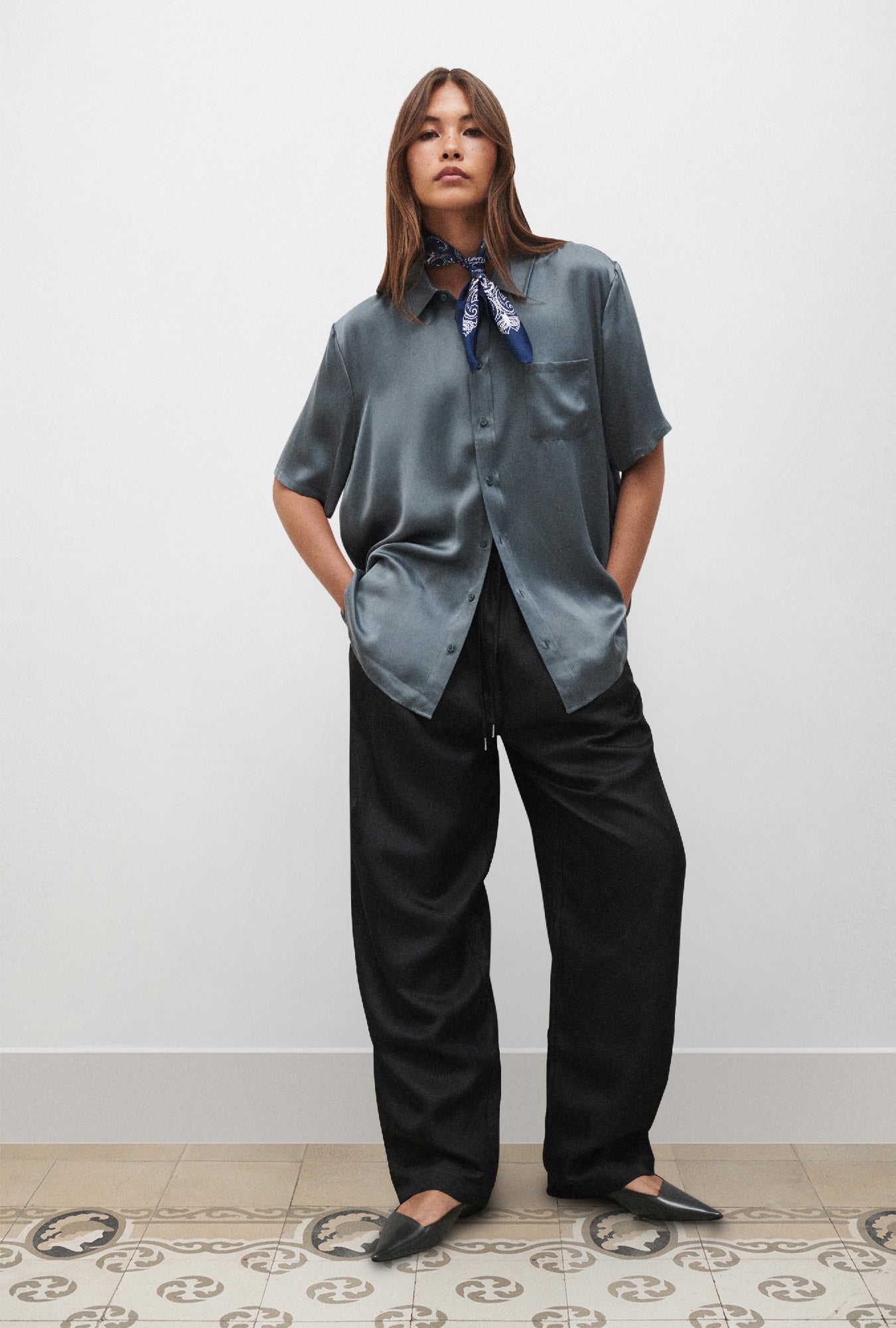 Image of a model wearing Tops. Product name - Short Sleeve Boyfriend Shirt Slate in Slate colour by brand - Silk Laundry