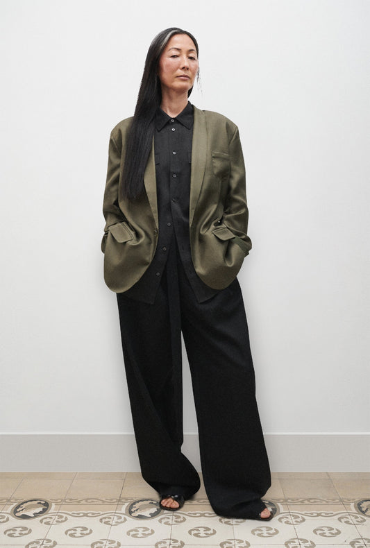 Image of a model wearing Outerwear. Product name - Twill Miami Blazer Pine in Pine colour by brand - Silk Laundry