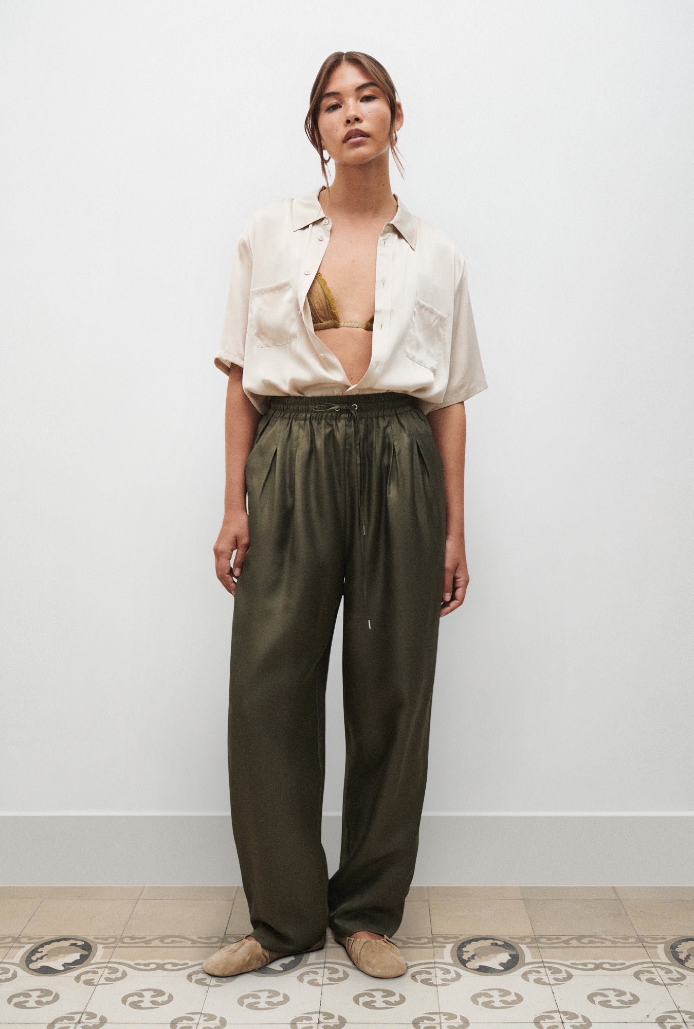 Image of a model wearing Pants. Product name - Twill Slouch Pants Pine in Pine colour by brand - Silk Laundry