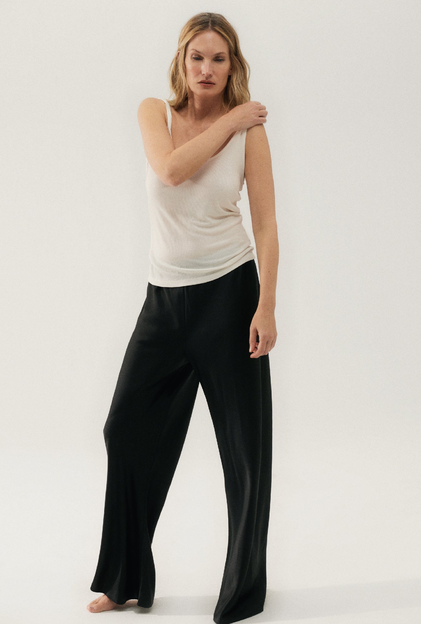 Image of a model wearing Tops. Product name - Ribbed Tank White in White colour by brand - Silk Laundry