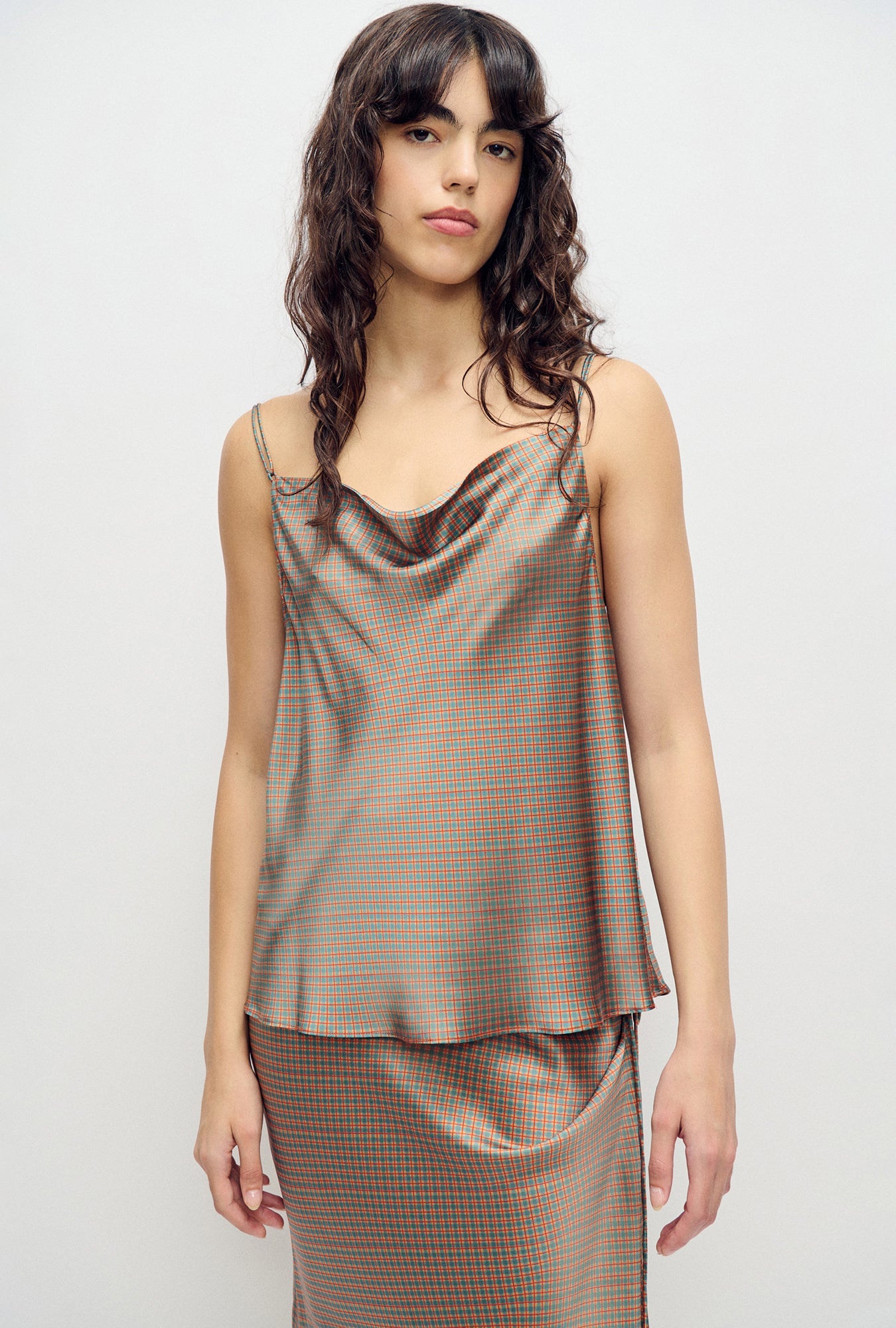 Image of a model wearing Tops. Product name - Drape Cami Micro Plaid in Micro Plaid colour by brand - Silk Laundry