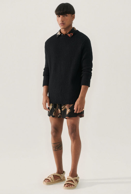 Image of a model wearing Tops. Product name - Knit Crewneck Black in Black colour by brand - Silk Laundry