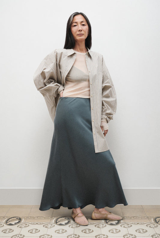Image of a model wearing Skirts. Productname: Long Bias Cut Skirt Slate in Slate colour by brand - Silk Laundry