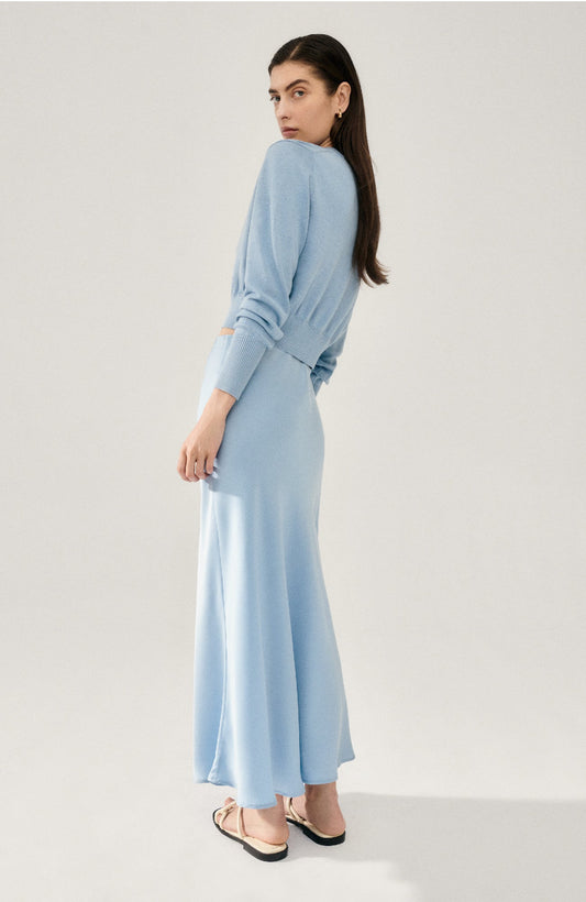 Image of a model wearing Skirts. Productname: Long Bias Cut Skirt Sky in Sky colour by brand - Silk Laundry