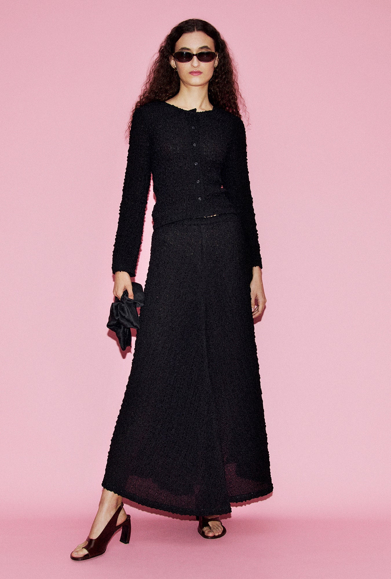 Image of a model wearing Tops. Product name - Pebble Long Sleeve Elena Top Black in Black colour by brand - Silk Laundry