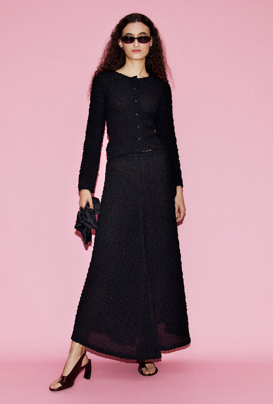 Image of a model wearing Tops. Product name - Pebble Long Sleeve Elena Top Black in Black colour by brand - Silk Laundry