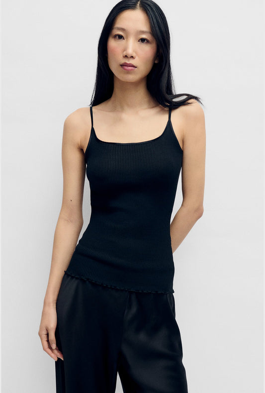 Image of a model wearing Tops. Product name - Silk Wool Ribbed Essential Cami Black in Black colour by brand - Silk Laundry