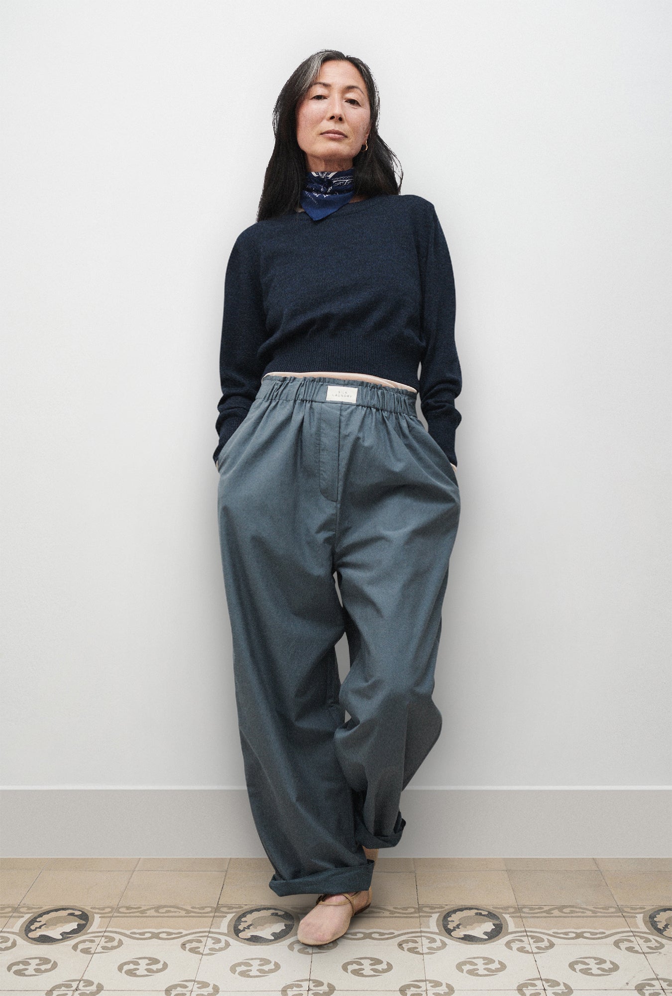 Image of a model wearing Pants. Product name - Cotton Silk Paper Bag Pants Slate in Slate colour by brand - Silk Laundry